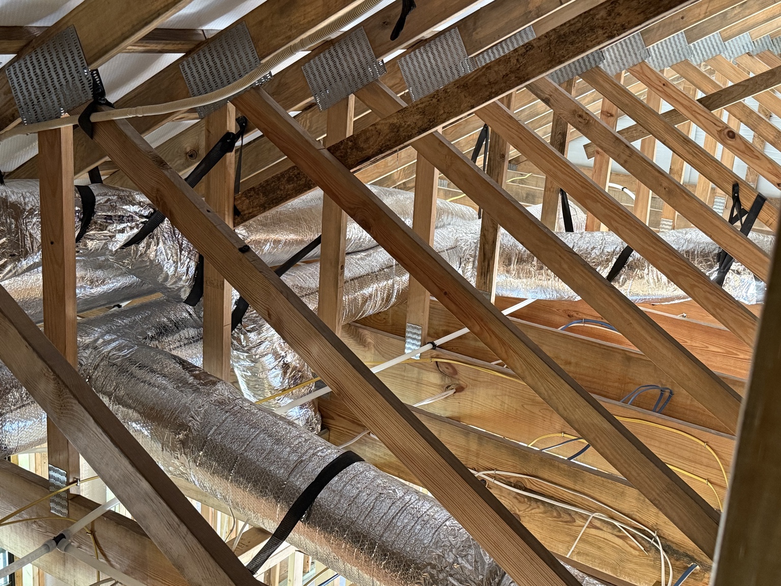 Insulated HVAC ductwork running through an attic in Shreveport, Louisiana
